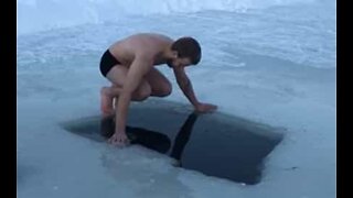 Man casually bathes in frozen lake