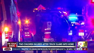 Two children injured after truck crashes into home