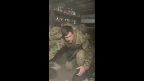 Ukrainan forces apparently taking cover in a cellar while explosions happen above them