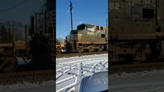 Open coil car on a snowy drive by