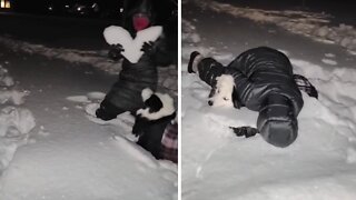 Playful dog breaks woman's snow-made heart