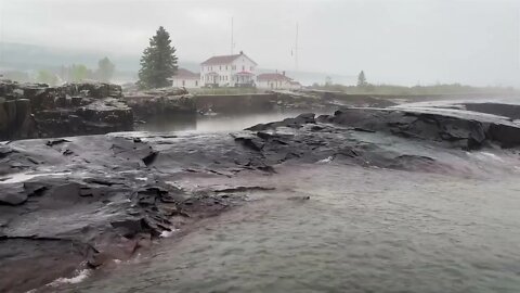 Rain over rocks at the US Coast Guard Station in Grand Marais by Lake Superior