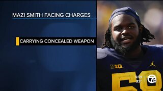 U-M DL Mazi Smith charged with carrying a concealed weapon, will continue to be with team