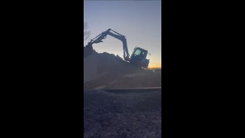 Takeuchi excavator climbing giant sand pile