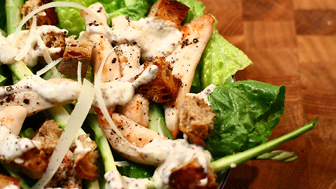 Healthy chicken Caesar salad with Parmesan and mustard dressing