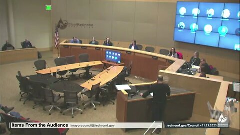 Ari reads the names of children held hostage at the Redmond City Council meeting