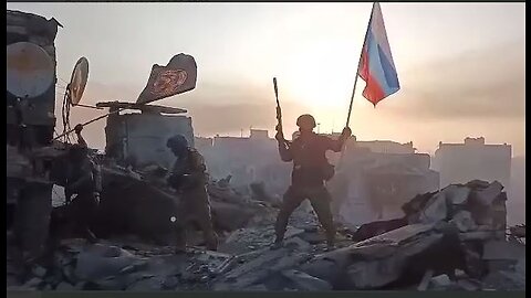 Russian soldiers raise the Russian flag after historic victory in Bakhmut, Ukraine