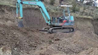 Yanmar YB 451 Excavator Digging On The Hillside