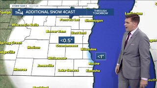 Snow showers continue, then temperatures drop