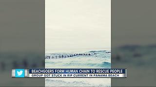 Beachgoers form human chain to rescue family in water