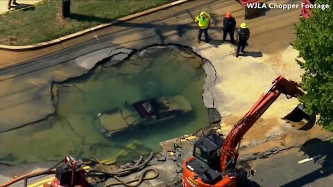 Chopper footage shows car completely submerged in gigantic sinkhole off Crain Hwy