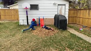 Son and Daughter Charge A Fall Leaf Pile-Autumn Fun