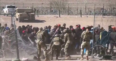 Hundreds of illegals overrunning Texas National Guard soldiers & forcing their way past razor wire