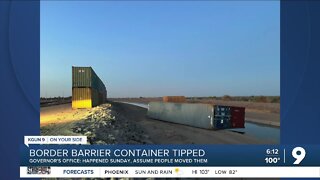 Two toppled border wall shipping containers now welded in place