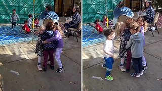 Classmates embrace kid after returning from hospital for his twin brother