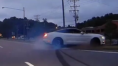 Mustang driver tries to show off when light turn green and loses control.