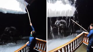 Avalanche of snow falls off mountain home