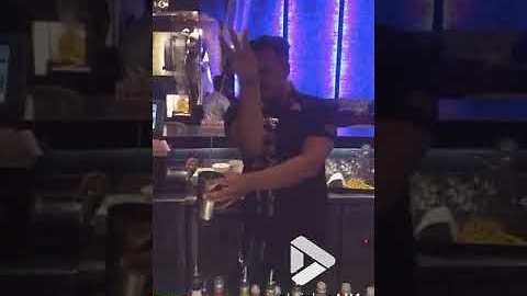 Barman performs mysterious floating bottle trick