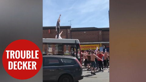 England fans celebrating by surfing on a bus
