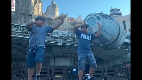 Twin dancers show off fun routine in front of Millennium Falcon