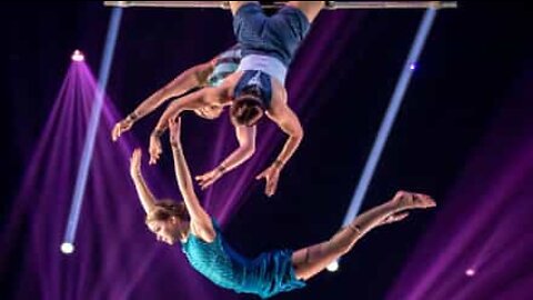 Trapeze artists perform amazing feat