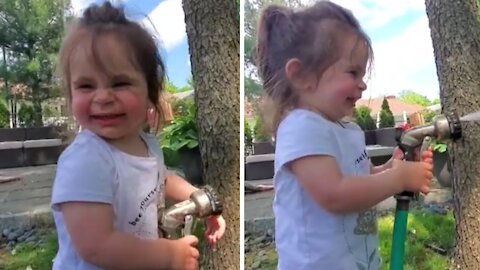Toddler Hilariously Tries To Catch Water From Garden Hose