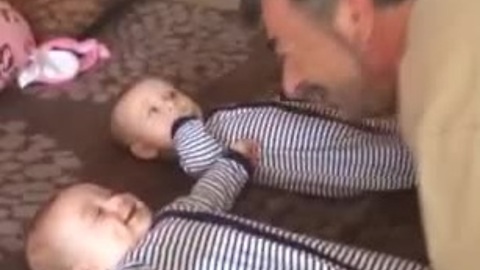 Grandpa makes twins laugh simultaneously