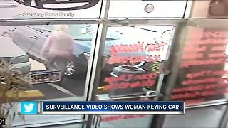 Surveillance video shows woman keying car