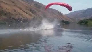 Fearless paraglider smoothly lands in water