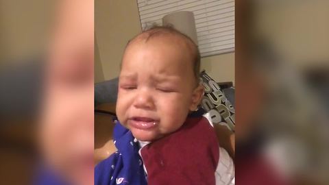 A Baby Boy Cries While Looking At Himself On Camera
