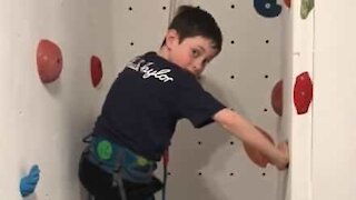 Dad builds climbing wall over stairs in house