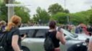 Video: Car drives through barricade at Lawrence protest