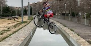 Cycling pro defies gravity jumping over canals