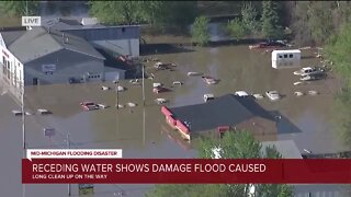 Receding water shows damage flood caused