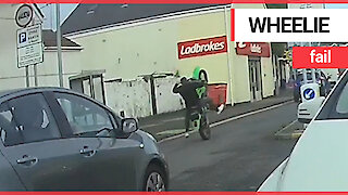 Idiot motorist falls off motorbike without any protective gear after attempting a wheelie