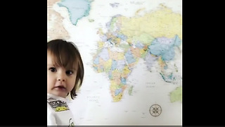 Smart toddler correctly points to various locations on map