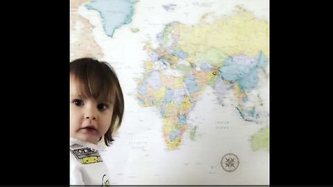 Smart toddler correctly points to various locations on map