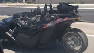 Batman seen cruising the highway in his Batmobile