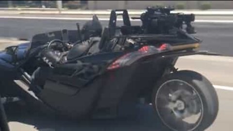 Batman seen cruising the highway in his Batmobile
