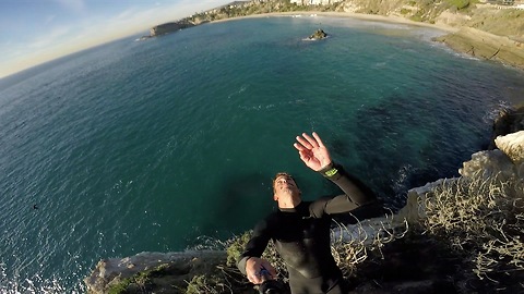 Guy pulls off epic back flip off cliff with GoPro in hand