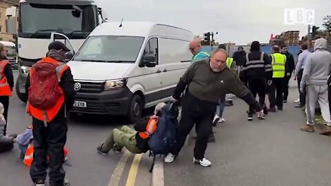 Fed-up drivers forcibly drag away environmentalist protesters blocking traffic outside London