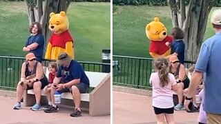 Winnie the Pooh mascot sneaks up on unsuspecting man