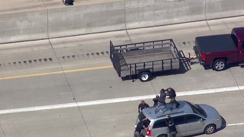 Watch as Detroit police tackle a chase suspect on top of a car