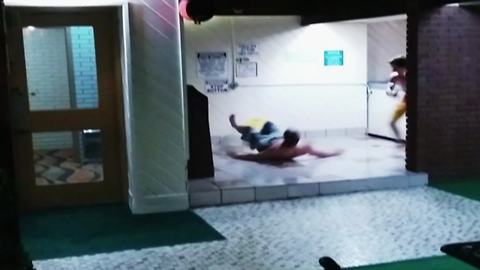 A Young Man Slips On A Floor And Slides Into A Wall