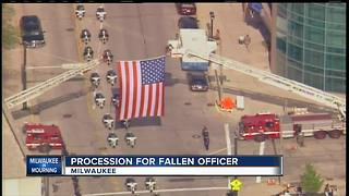 Community pays respects to officer at procession