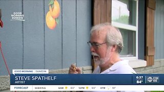 Local artist paints oranges on hundreds of Dunedin homes