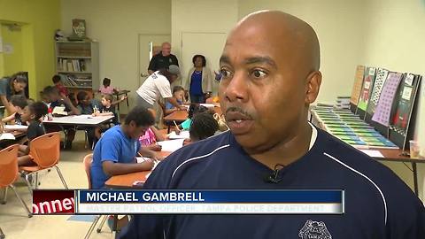 Tampa police officers helping kids with reading, writing skills during the summer