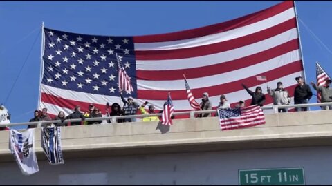 THE PEOPLES CONVOY HOIST MASSIVE AMERICAN FLAG WHILE CHANTING LETS GO BRANDON