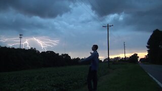 Striking A Perfectly Timed Pose As Lightning Strikes At Sunset 4K