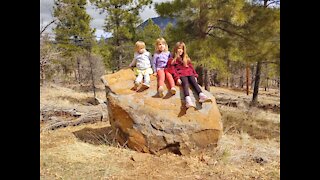 Sisters take picture on rock, the younger is done!